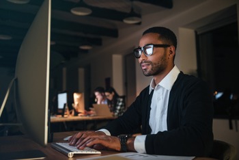 Man reading press release on a computer